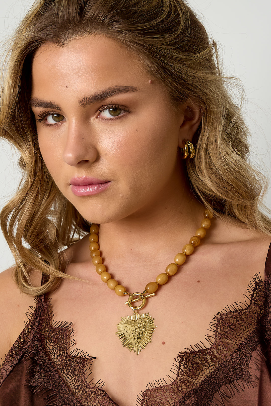 Bead necklace with front closure charm