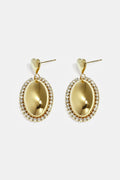 Statement oorbellen met ovale charm omringd met steentjes